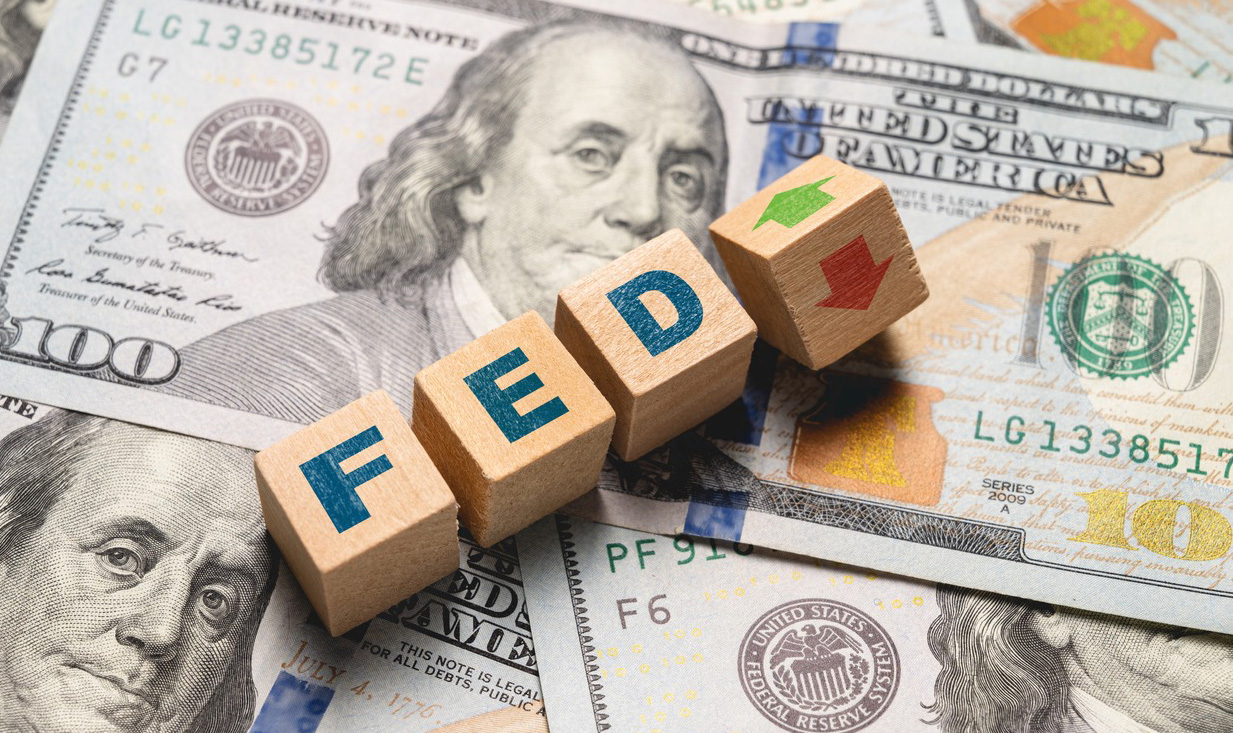 Picture of Money and blocks on top that say "Fed"