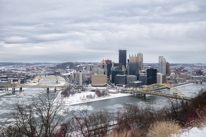 Snow covered town next to a river