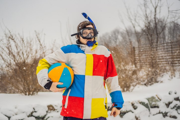 Person with beachball and snorkle mask on in the snow