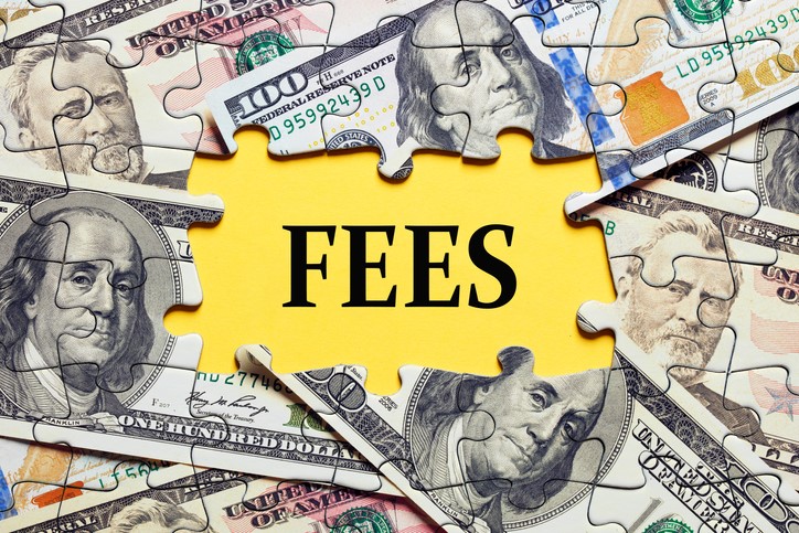 The word 'fees' set atop hundred dollar bills