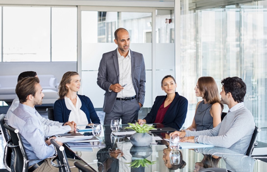 People in a meeting, sitting at a table