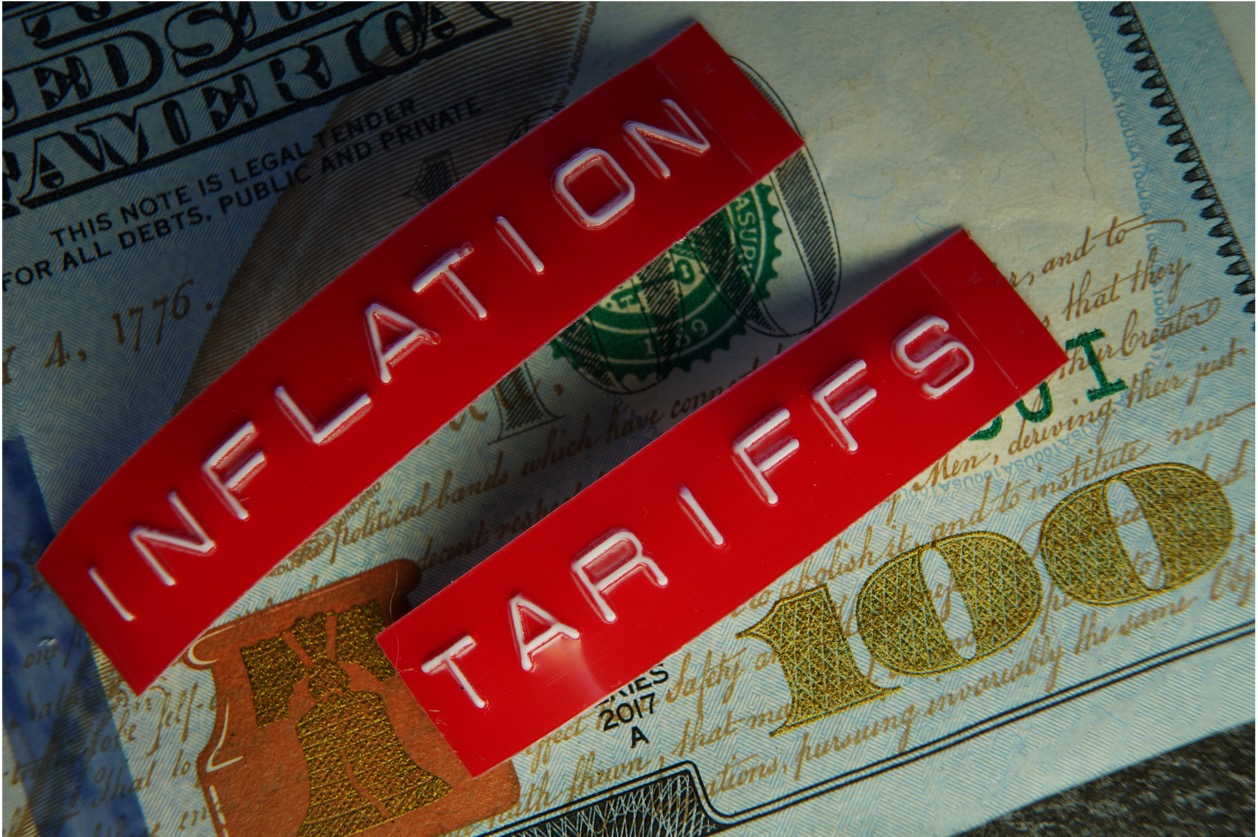 Words Inflation and Tariffs over a 100 dollar bill