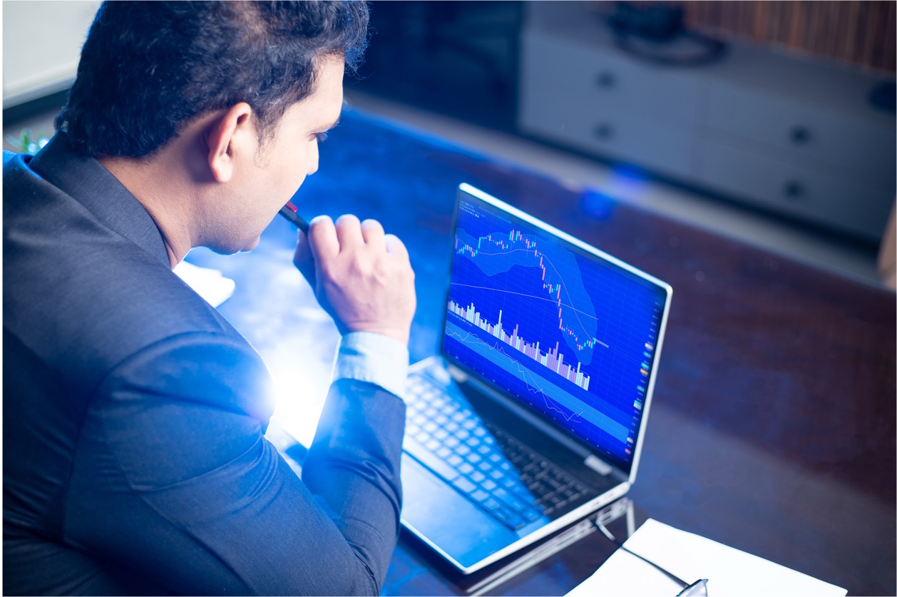 Man looking at pricing chart on laptop