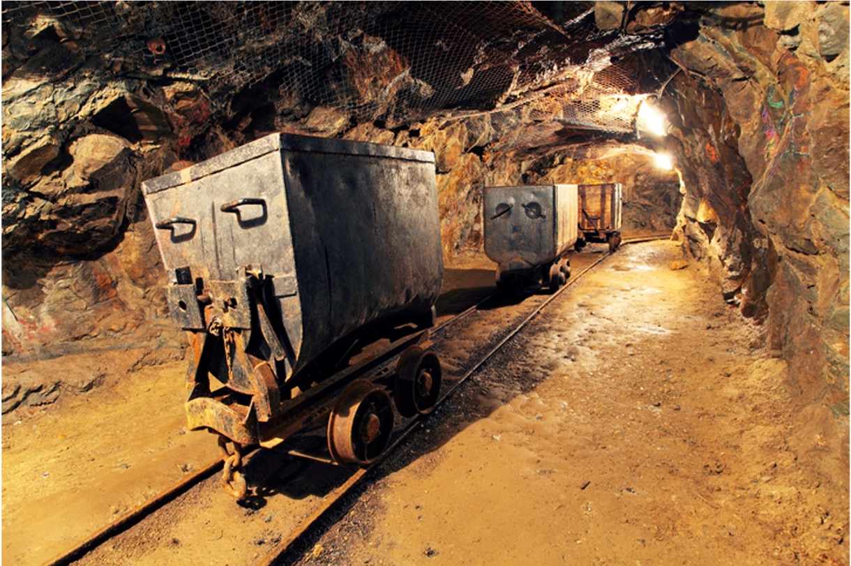 Image of coal carts in a coal mine tunnel
