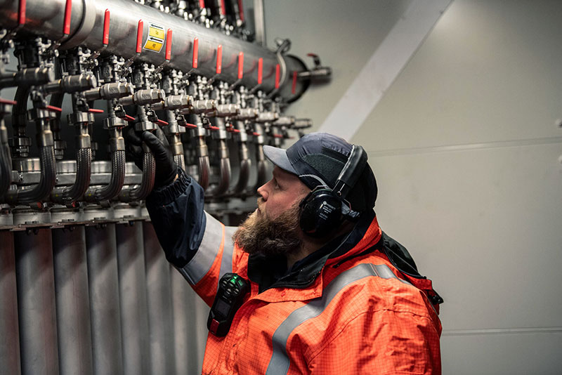 Man checking pipe valves