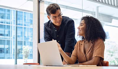 Man and woman have discussion in front of a computer